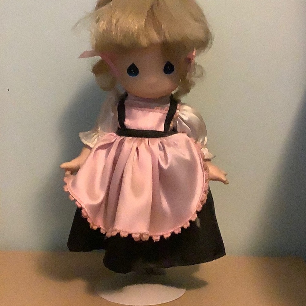 Precious Moments doll with display stand.